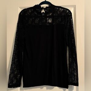 Black shirt with lace at the neckline and sleeves